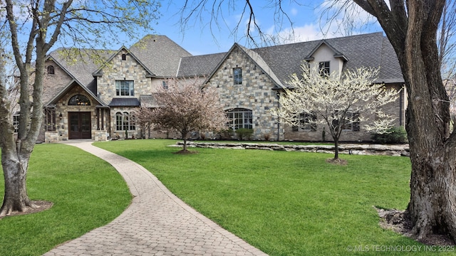 9931 N Chadford Rd, Owasso, OK 74055 - french country inspired facade featuring stone siding and a front yard