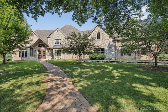 9931 N Chadford Rd, Owasso, OK 74055 - view of front facade featuring stone siding, a front lawn, and french doors