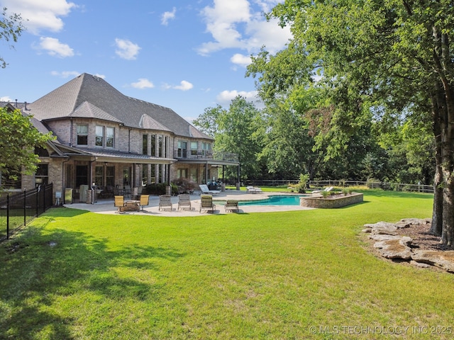 9931 N Chadford Rd, Owasso, OK 74055 - back of house with a patio, a fenced backyard, a balcony, and stone siding