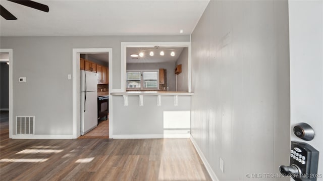 345 N Pine, Dewey, OK 74029 - unfurnished living room featuring light wood-style flooring, a ceiling fan, and baseboards