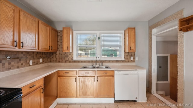 345 N Pine, Dewey, OK 74029 - kitchen featuring dishwasher, a sink, light tile patterned floors, light countertops, and tasteful backsplash