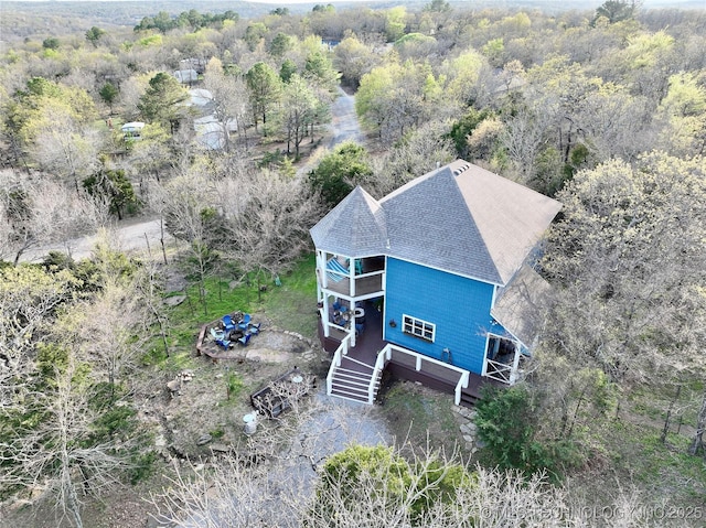birds eye view of property with a forest view