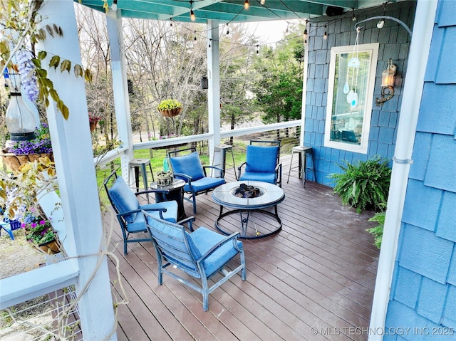 wooden deck with an outdoor fire pit