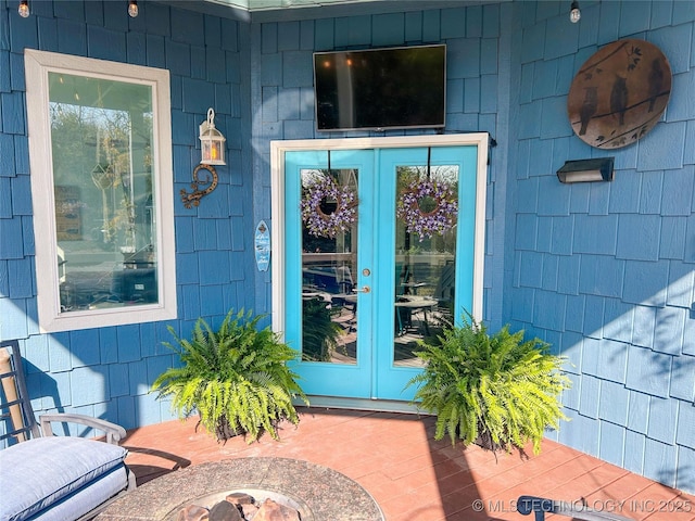 view of exterior entry featuring french doors