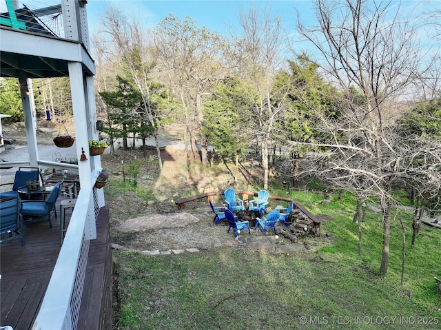 view of yard featuring an outdoor fire pit and a wooden deck
