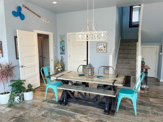 dining area featuring stairs and wood finished floors