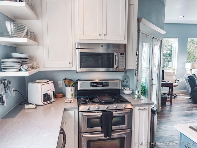 kitchen featuring white cabinets, open shelves, light countertops, and stainless steel appliances
