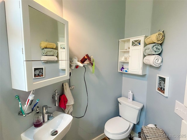 half bath with a sink and toilet