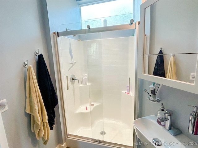bathroom with a sink and a stall shower