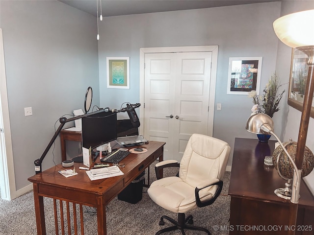 carpeted home office featuring baseboards