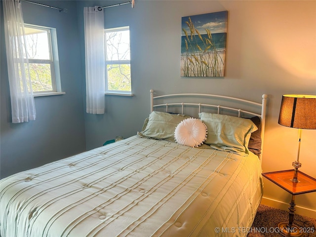 bedroom featuring multiple windows