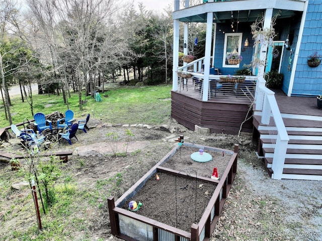 view of yard featuring a fire pit and a vegetable garden