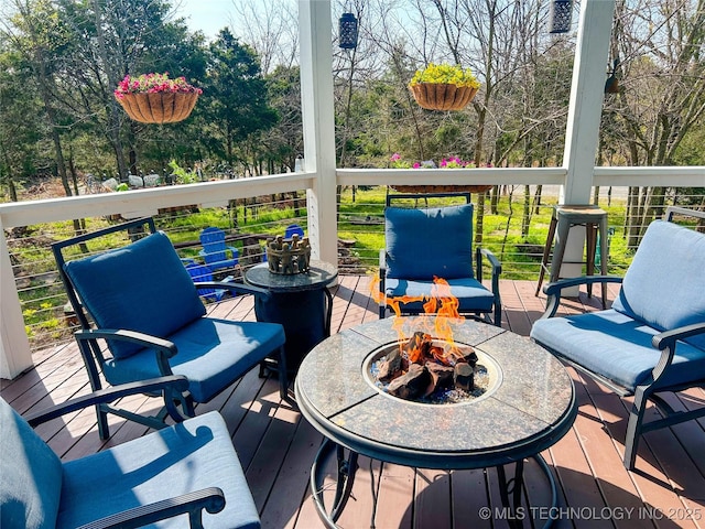 wooden terrace featuring a fire pit