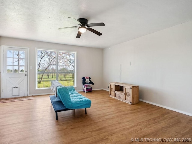 511 Tandy Walker, Silo, OK 74701 - living area featuring light wood-style flooring, a ceiling fan, baseboards, and a textured ceiling