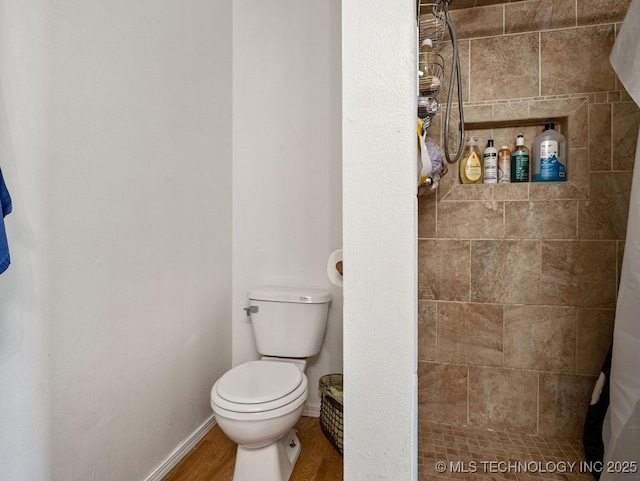 511 Tandy Walker, Silo, OK 74701 - full bath featuring a shower stall, baseboards, toilet, and wood finished floors
