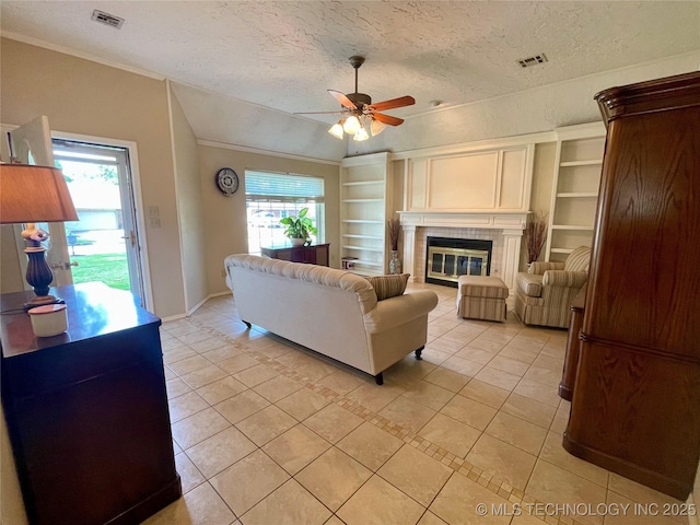living room with plenty of natural light, a textured ceiling, ceiling fan, and visible vents