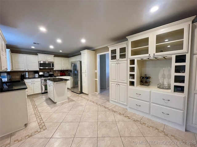 kitchen with decorative backsplash, stainless steel appliances, crown molding, and recessed lighting
