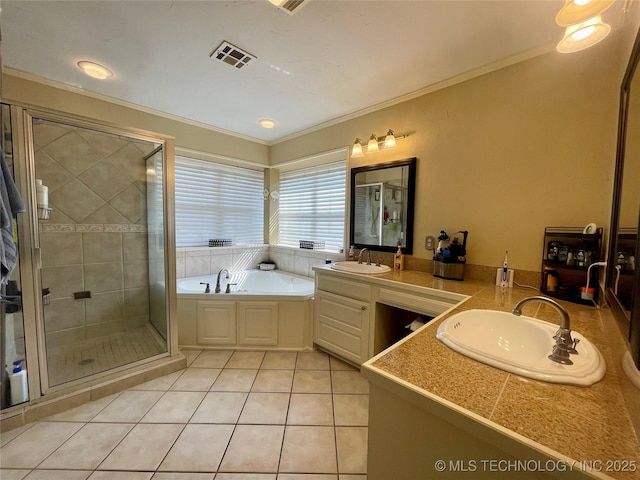 full bathroom featuring a stall shower, tile patterned floors, visible vents, and a sink