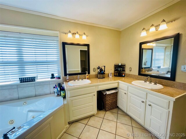 full bathroom featuring ornamental molding, a sink, tile patterned floors, and a whirlpool tub