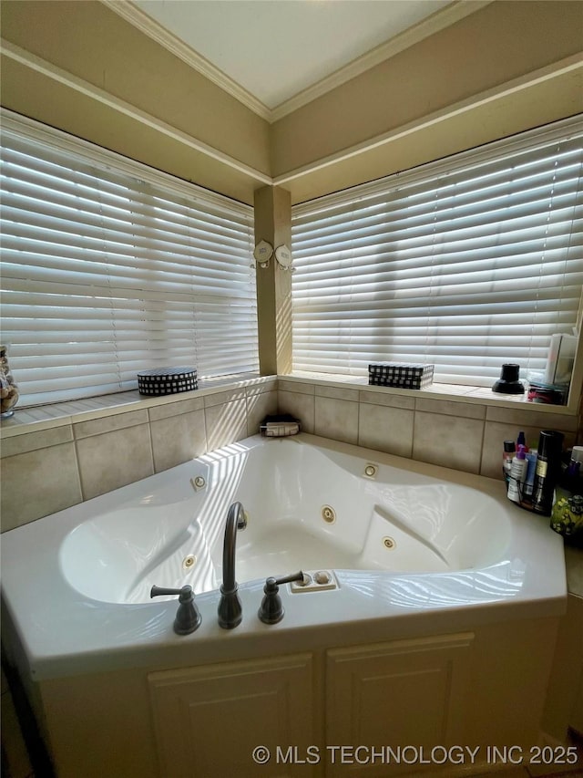 bathroom with a tub with jets and ornamental molding