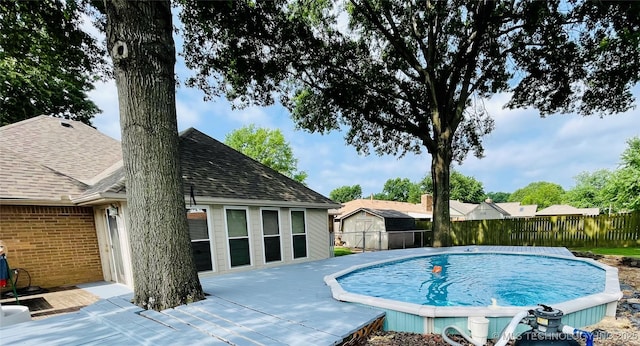view of pool with fence, a wooden deck, and a fenced in pool