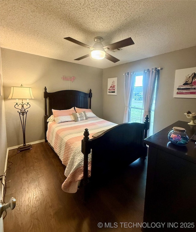 bedroom with a textured ceiling, wood finished floors, and ceiling fan