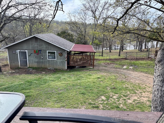view of yard with an outdoor structure and fence