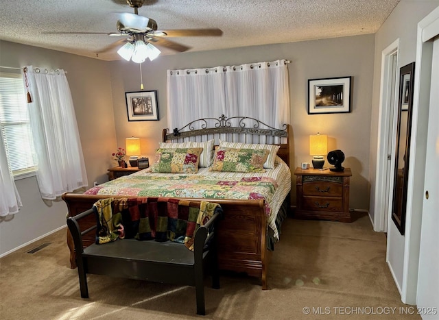 bedroom featuring a textured ceiling, baseboards, visible vents, ceiling fan, and carpet