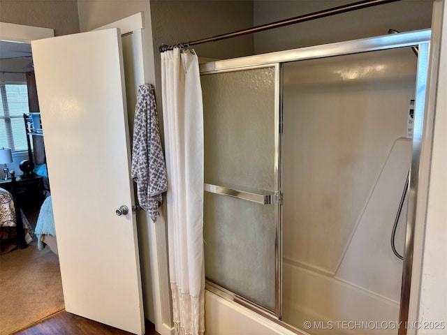 bathroom featuring ensuite bathroom and enclosed tub / shower combo