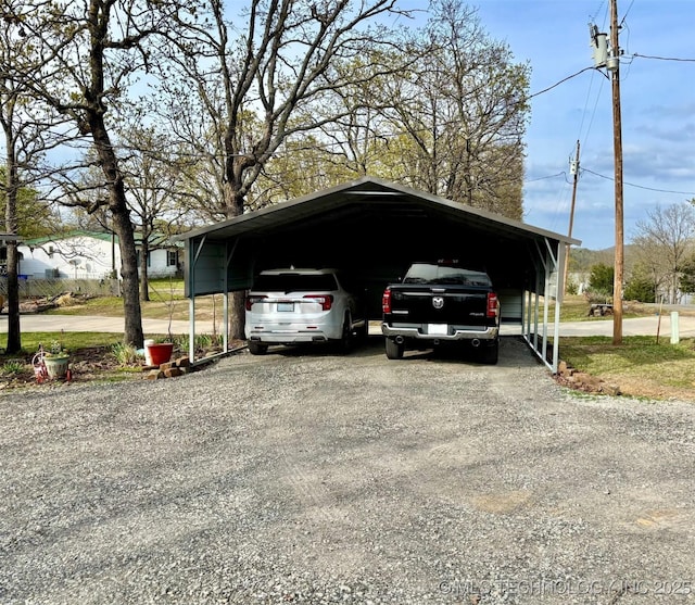 view of vehicle parking with driveway and a detached carport