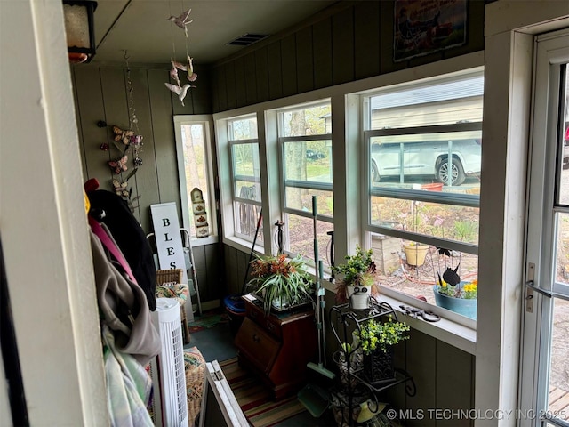 sunroom / solarium with wooden walls and visible vents