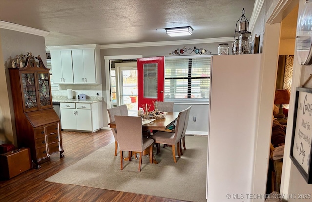 dining room featuring crown molding, a textured ceiling, and wood finished floors