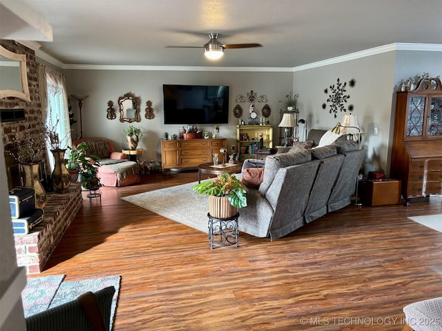 living room featuring crown molding, wood finished floors, and a ceiling fan
