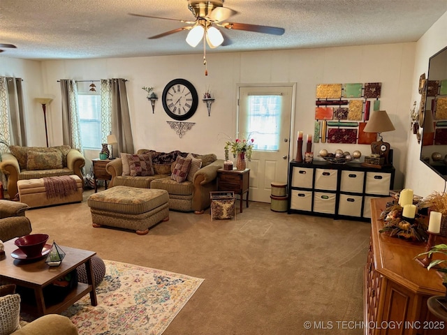carpeted living room with a textured ceiling, a wealth of natural light, and a ceiling fan