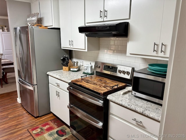 kitchen with white cabinetry, tasteful backsplash, stainless steel appliances, under cabinet range hood, and wood finished floors