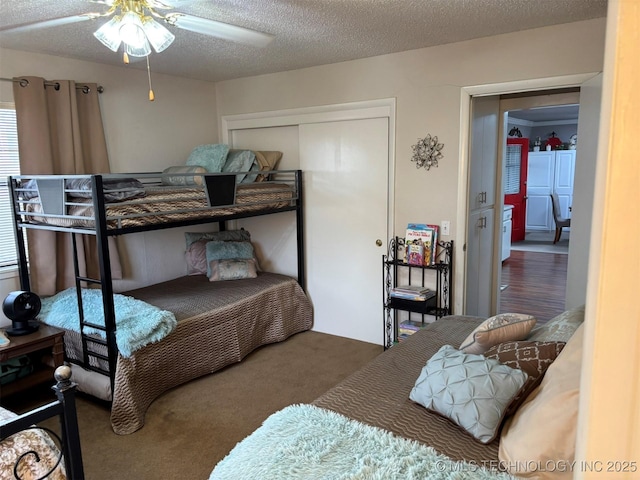 bedroom featuring a closet, carpet floors, and a textured ceiling