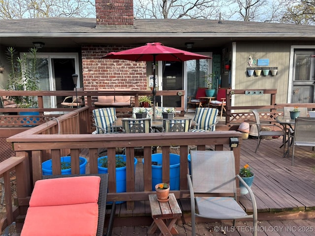 wooden terrace featuring outdoor dining area