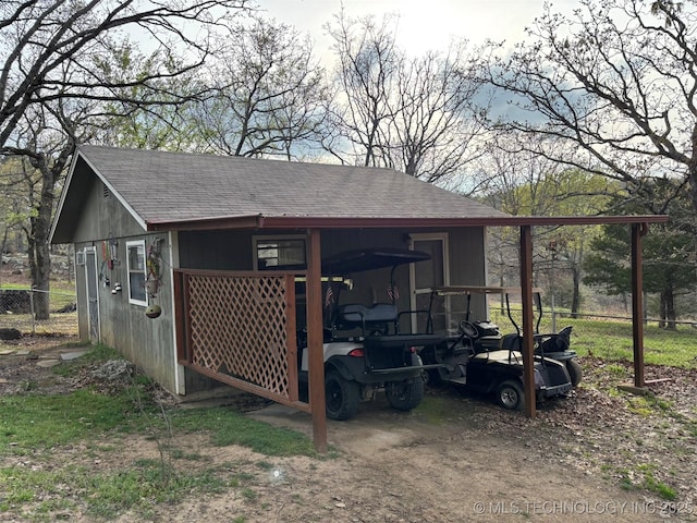 view of pole building with a carport and fence