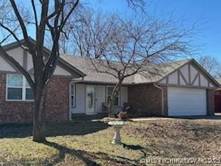 1009 W 18th St, Claremore, OK 74017 - view of front of home featuring an attached garage, brick siding, and a front lawn