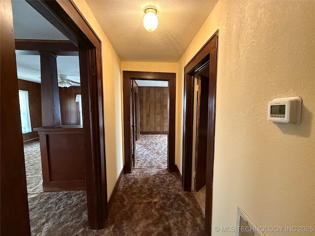 609 N E St, Mcalester, OK 74501 - hall featuring dark colored carpet, a textured wall, and a textured ceiling