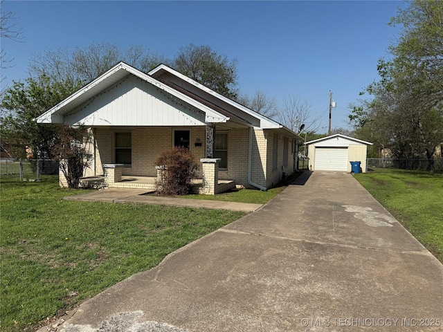 609 N E St, Mcalester, OK 74501 - view of front of house featuring an outbuilding, brick siding, fence, and a front lawn