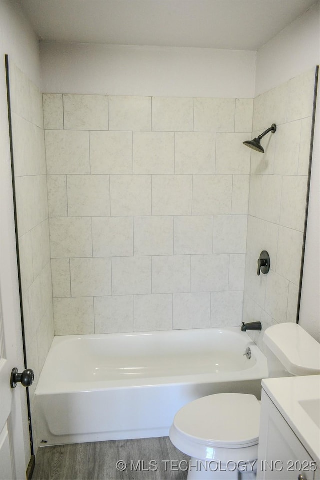 bathroom with toilet, vanity, bathtub / shower combination, and wood finished floors