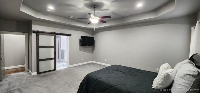 17078 S 11th W Ave, Glenpool, OK 74033 - bedroom with a barn door, a tray ceiling, carpet, recessed lighting, and a ceiling fan