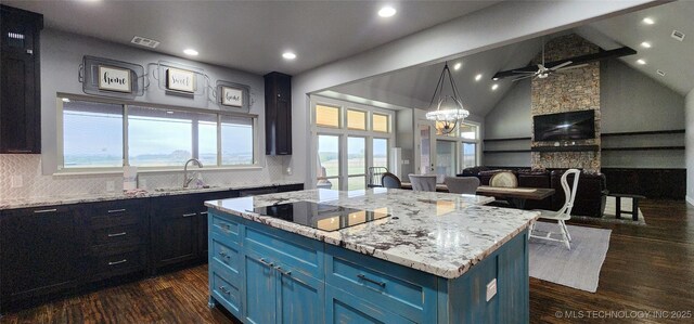 17078 S 11th W Ave, Glenpool, OK 74033 - kitchen with black electric cooktop, blue cabinetry, backsplash, a kitchen island, and recessed lighting