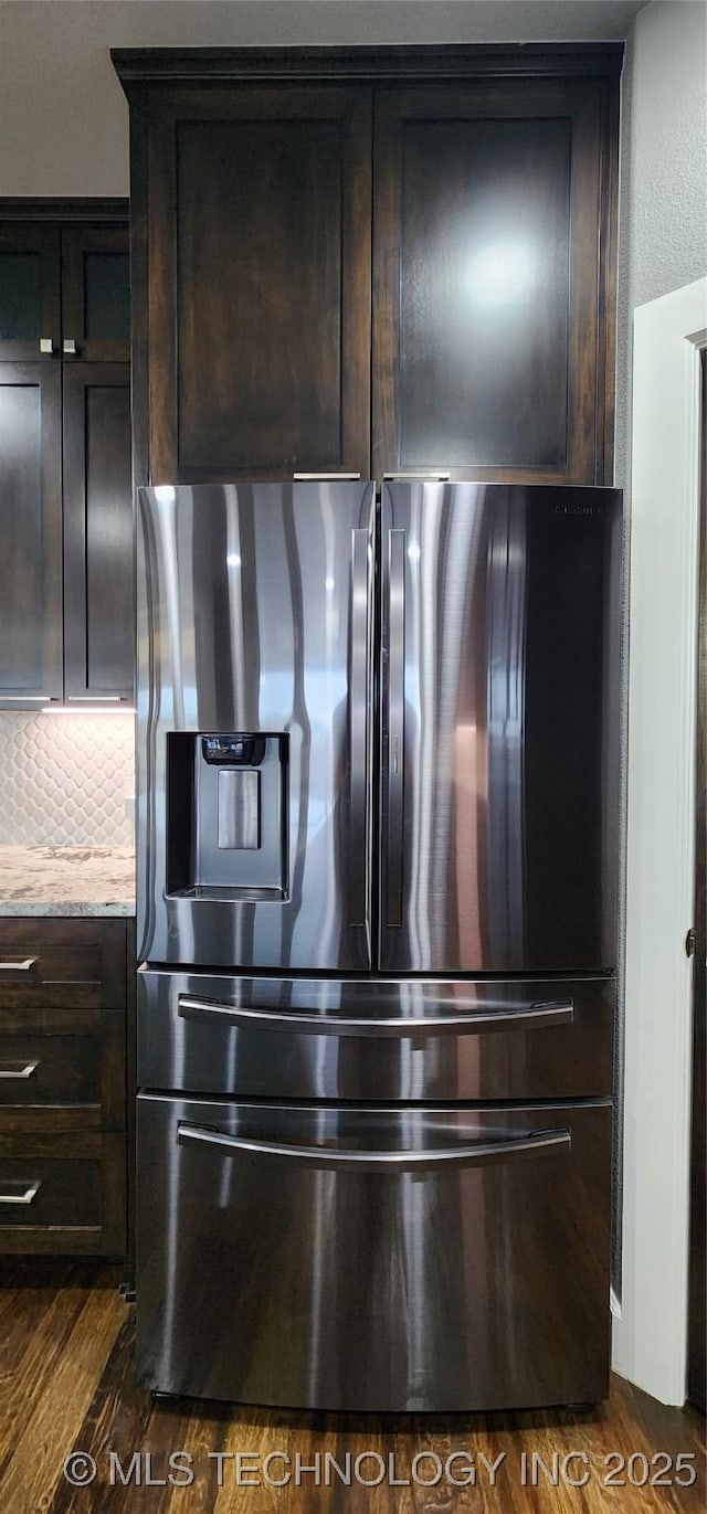 17078 S 11th W Ave, Glenpool, OK 74033 - detailed view of stainless steel fridge, dark wood finished floors, light stone counters, and dark brown cabinets