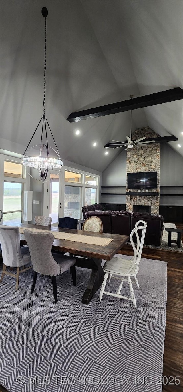 17078 S 11th W Ave, Glenpool, OK 74033 - dining space featuring wood finished floors, a chandelier, a stone fireplace, beam ceiling, and high vaulted ceiling