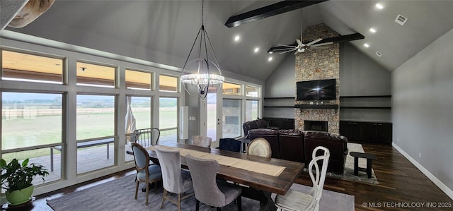 17078 S 11th W Ave, Glenpool, OK 74033 - dining area with high vaulted ceiling, dark wood-style flooring, a stone fireplace, a chandelier, and a ceiling fan