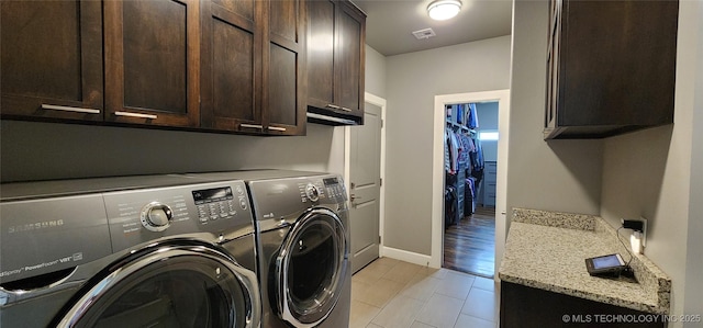 17078 S 11th W Ave, Glenpool, OK 74033 - laundry room featuring washing machine and dryer, cabinet space, and light tile patterned floors