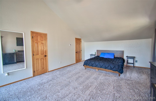 carpeted bedroom with baseboards and vaulted ceiling