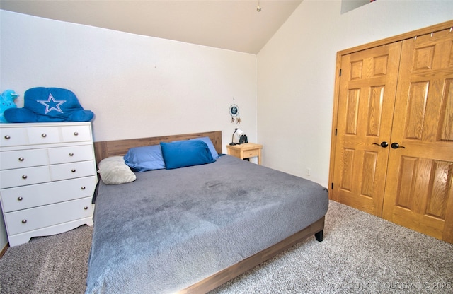 carpeted bedroom with lofted ceiling